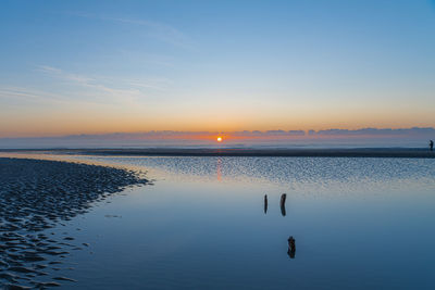 Scenic view of sea against sky during sunrise