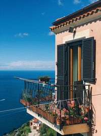 Building by sea against blue sky