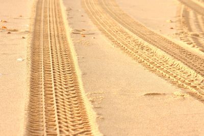 High angle view of tire tracks on dirt road