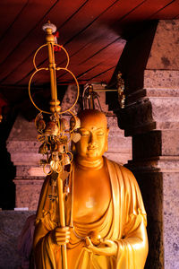 Statue of buddha against building