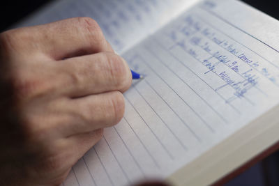 High angle view of person reading book