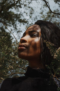 Close-up portrait of young woman looking away