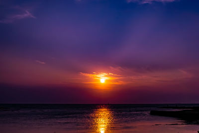 Scenic view of sea against romantic sky at sunset