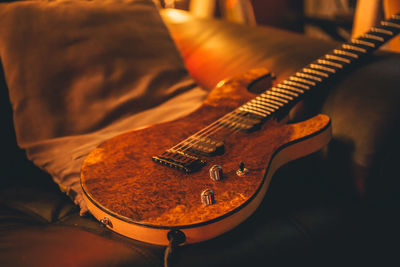 High angle view of guitar on sofa