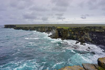 Amazing view of waves breaking on the cliffs of inishmore, aran islands in ireland