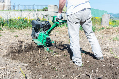 Low section of man working in mud