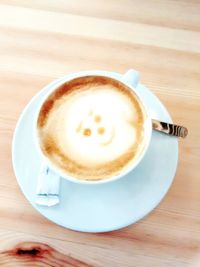 High angle view of coffee on wooden table