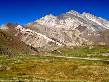 Scenic view of mountains against clear blue sky