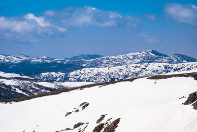 Scenic view of snow covered mountains against sky