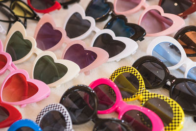 Close-up of multi colored sunglasses on table
