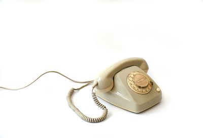 Close-up of telephone booth against white background