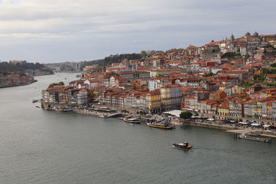 High angle view of buildings by sea against sky