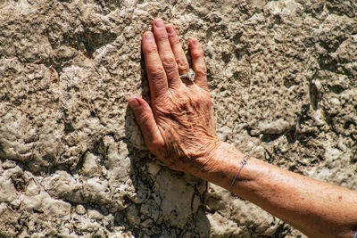 Close-up of hand in mud