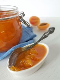 Close-up of orange juice in jar on table