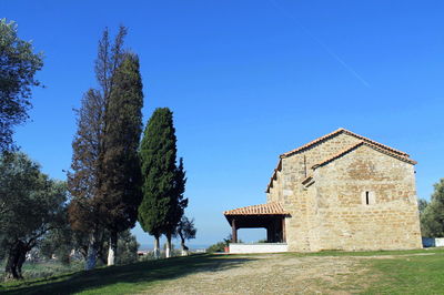 Low angle view of built structure against clear blue sky