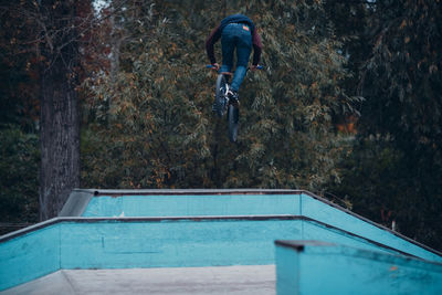 Man jumping in swimming pool