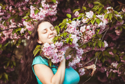 Portrait of woman with pink flowers