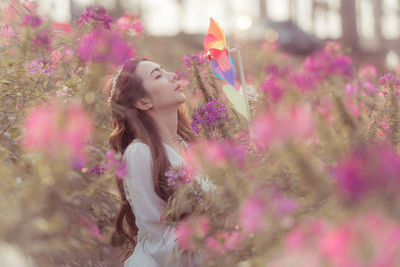 Portrait of woman with pink flowers