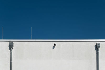 Low angle view of street light against clear blue sky