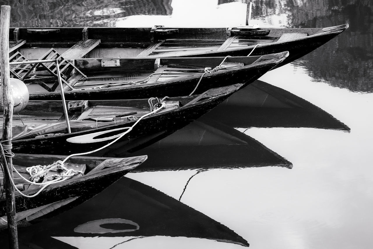 BOATS MOORED IN LAKE