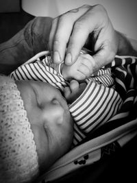 Close-up of baby sleeping with hands