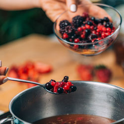 Fruit canning preservation. woman cooking fruits and making homemade jam.