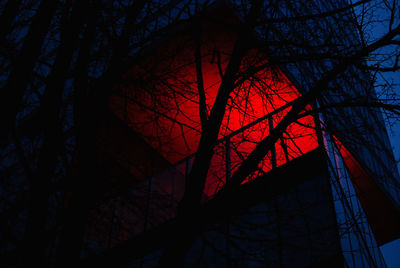 Low angle view of bare tree against building