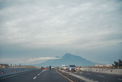 Road by city against sky