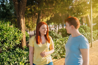 Lesbian couple standing by plants