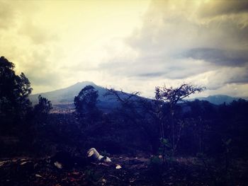 Scenic view of mountains against cloudy sky