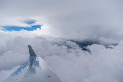 Aerial view of cloudscape over airplane wing