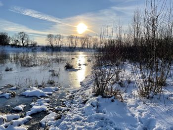 Frozen lake against sky during winter
