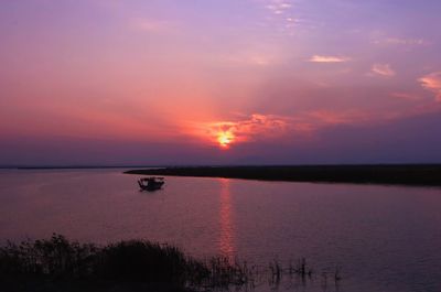 Scenic view of sea against romantic sky at sunset