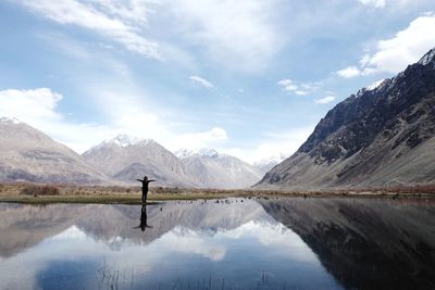 Scenic view of lake and mountains against sky