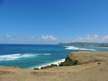 Scenic view of beach against blue sky