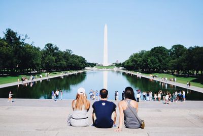 People against reflecting pool and washington monument