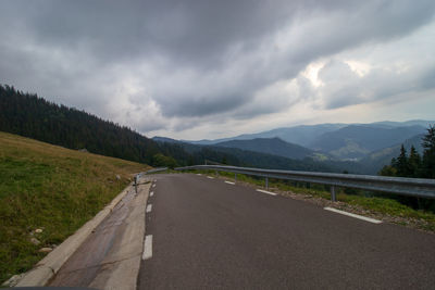 Empty road along countryside landscape