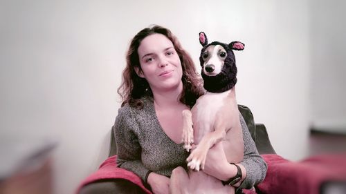 Portrait of happy woman with arms raised