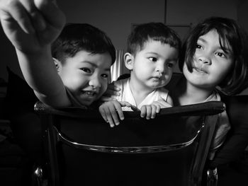 Children on chair at home