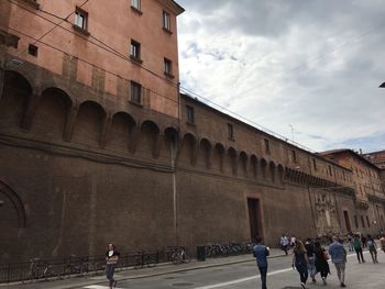 People walking in front of historical building