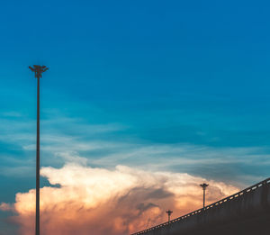 Low angle view of silhouette street light against sky