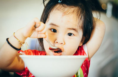 Portrait of cute girl eating food