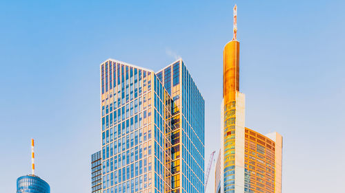 Low angle view of modern buildings against clear blue sky in frankfurt am main, germany