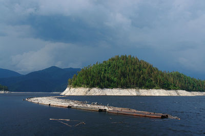 Scenic view of river against sky. drift wood collector