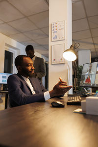 Side view of business colleagues working at office