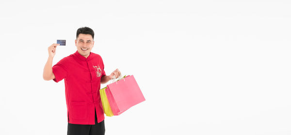 Man holding umbrella against white background