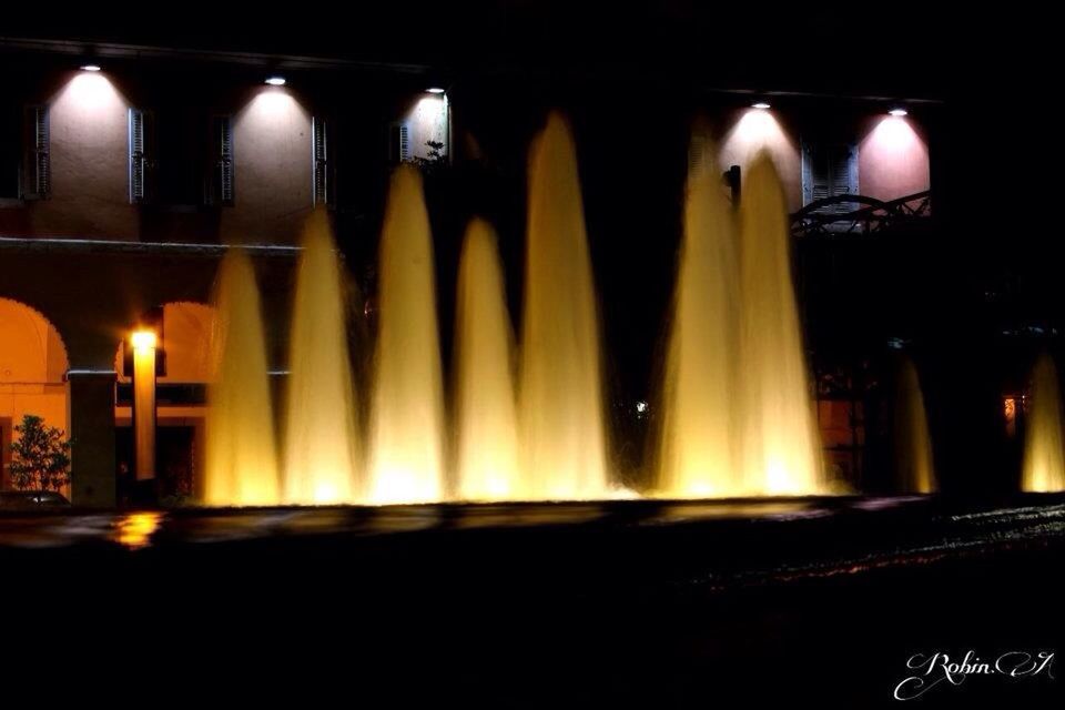 illuminated, night, architectural column, architecture, built structure, in a row, place of worship, column, history, religion, famous place, pillar, arch, spirituality, travel destinations, indoors, colonnade, building exterior, light - natural phenomenon, tourism