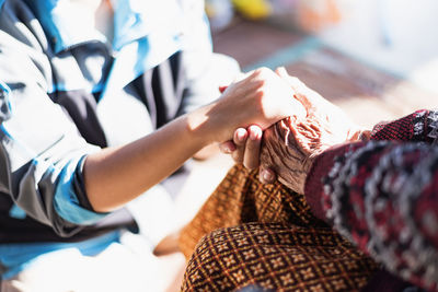 Midsection of woman holding hands