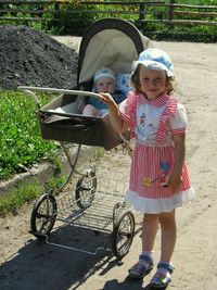 Full length of girl and daughter on grass