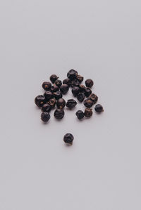 High angle view of coffee beans against white background